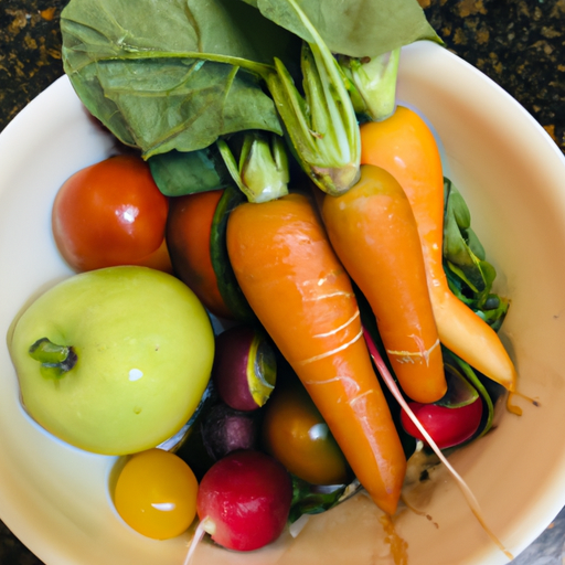 A close-up of a bowl of freshly picked, organic fruits and vegetables.