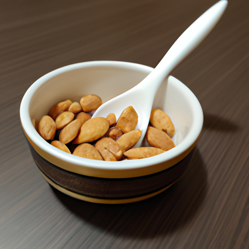 A bowl of almonds with a spoon dipped in the bowl.